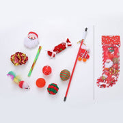 Assorted Christmas-themed cat toys including balls, a feather mouse, a Santa toy, and a festive stocking gift set